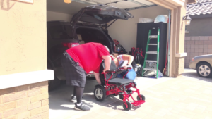 Dave and his wife working together to get his chair into his car.